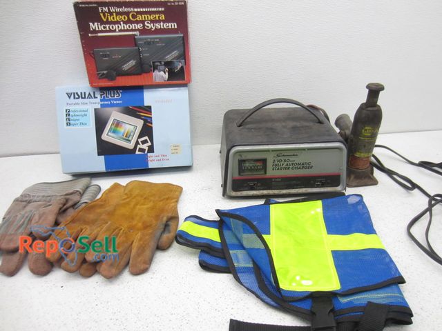 Lot 31-9410 - Schumacher starter/charger, work gloves, police safety vest, bottle jack, etc.