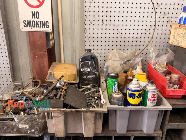 Lot 31-1107 - Contents on top of parts indexes. Drill bits, oil, chain lube, etc