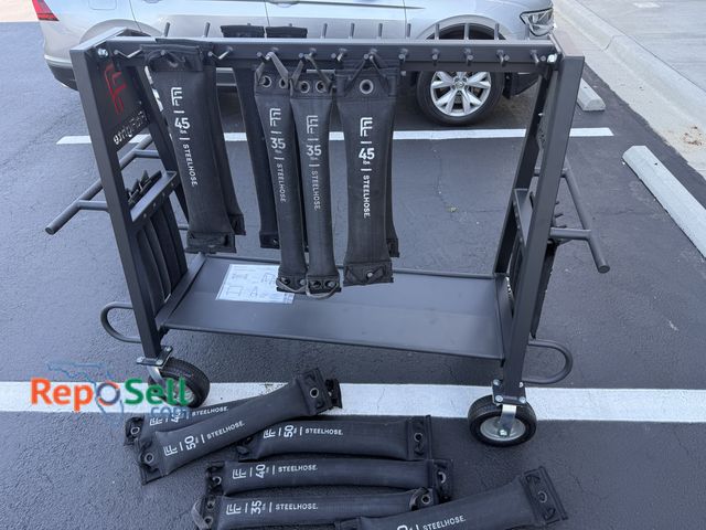 Lot 31-6306 - Fit Fighter  Mutt Steel Hose Carrier with approx (20) Steel Hose workout bags from 5-50lbs Shows Lit...