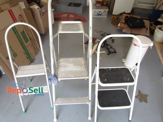 Lot 31-9209 - Three metal step ladders featuring white-painted frames. Includes a double-step stool with black tre...