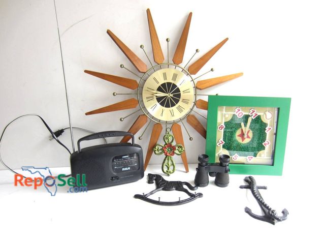 Lot 31-9241 - A mid-century style sunburst clock, an RCA portable radio, a framed baseball-themed analog clock, a ...