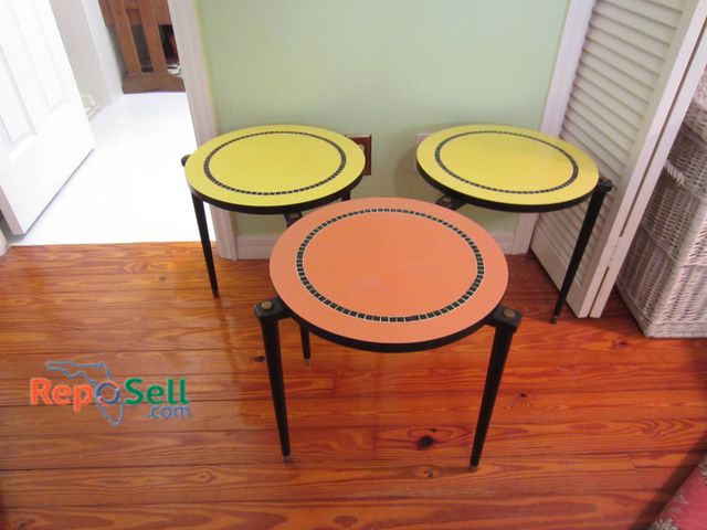 Lot 31-9037 - Three Side Tables With Round Tops In Yellow And Orange With Black Legs, 16-Inch Diameter.