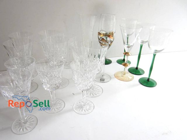 Lot 31-9238 - Clear and colored stemware including crystal goblets, green-stem wine glasses, and decorative pieces...