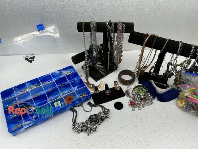 Lot 31-1417 - An assortment of costume jewelry such as necklaces, bracelets, earrings, rings, and pendants, displa...