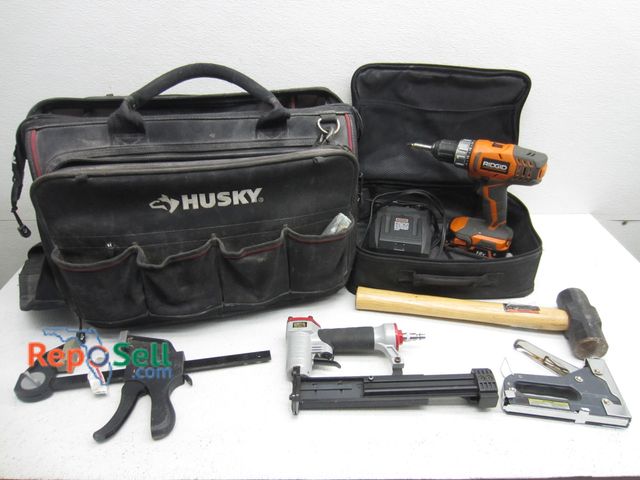 Lot 31-9250 - Large Husky Tool Bag, Ridgid Drill (Power On), Battery, Charger And Hand Tools