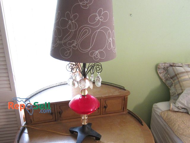 Lot 31-9030 - Electric table lamp with a purple shade, red glass base, and hanging crystal accents 33" H