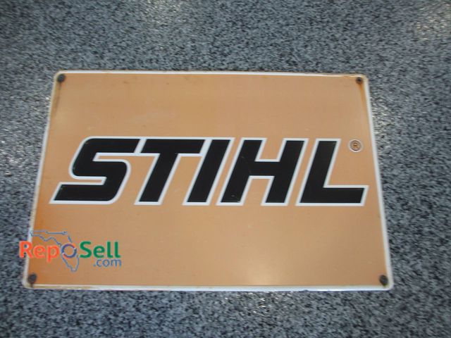 Lot 31-1177 - Single-sided metal sign featuring the Stihl logo in black text on an orange background. Measures app...