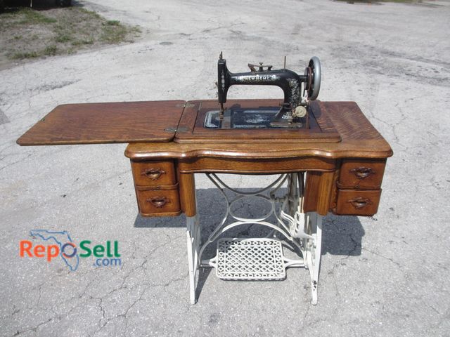 Lot 31-1104 - Vintage New Home Sewing Machine With Oak Wood And Metal Legs 34"x30"H