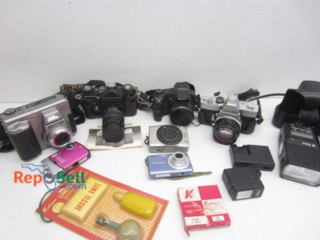Lot 31-8122 - Lot of Cameras &amp; Accessories: Camera Care Kit, Flashers, Cameras: Sony, Panasonic, Minolta, etc.