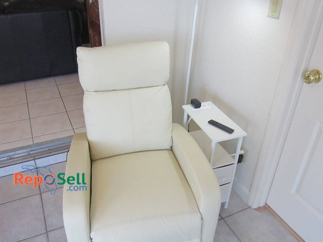 Lot 31-8606 - Cream Power Recliner Chair (powers on) With Remote, White Side Table And LED Lamp