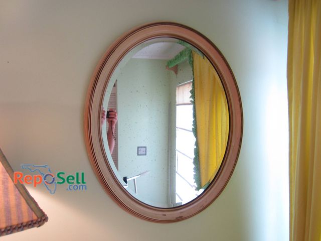 Lot 31-9034 - Oval Mirror Featuring A Pink Wooden Frame With Beveled Edge