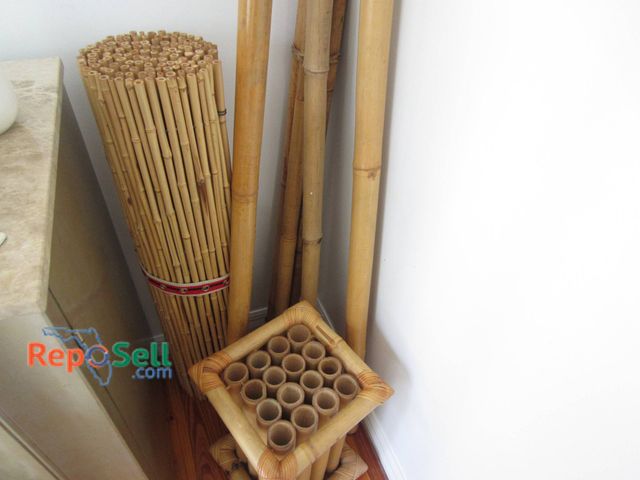 Lot 31-9111 - Bamboo Poles And One Rolled Bamboo Mat In Various Sizes And Heights.