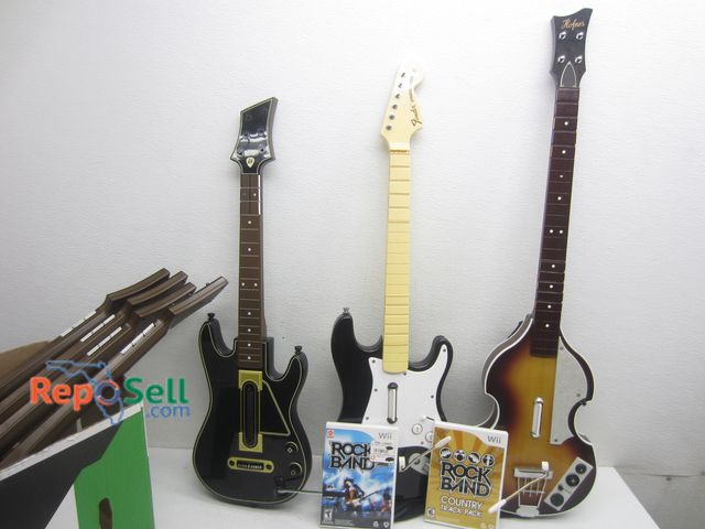 Lot 31-9337 - (7) Guitar Hero Guitars &amp; (2) Rock Band Games