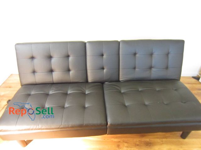 Lot 31-8644 - Modern Black Faux Leather Futon Sofa With Reclining Back And Cup Holders