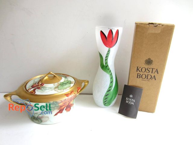 Lot 31-9300 - Includes a Kosta Boda tulip-patterned glass vase with original box and booklet, standing approximate...