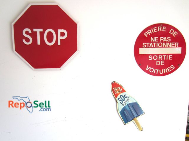 Lot 31-9142 - Three signs, including a red octagonal 'STOP' sign (approx. 14 inches tall), a round red French 'Ne ...