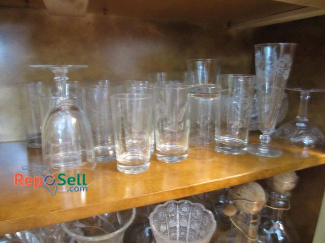 Lot 31-9240 - Clear glass and crystal items, including wine glasses, vases, etched highball glasses, and vessels w...
