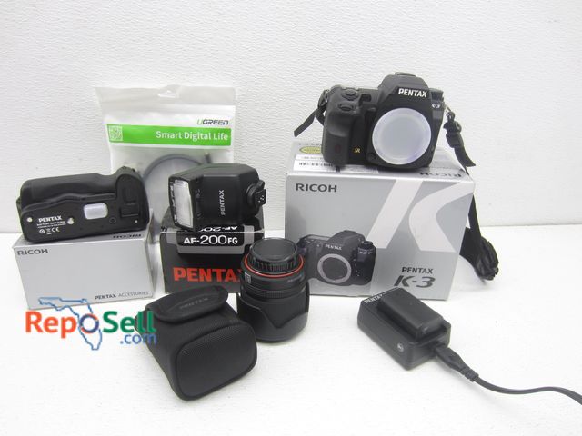 Lot 31-6090 - Pentax Camera &amp; Access: RICOH K-3 Camera w/(5) Batteries &amp; Charger (Powered On), 1- AF-200FG...