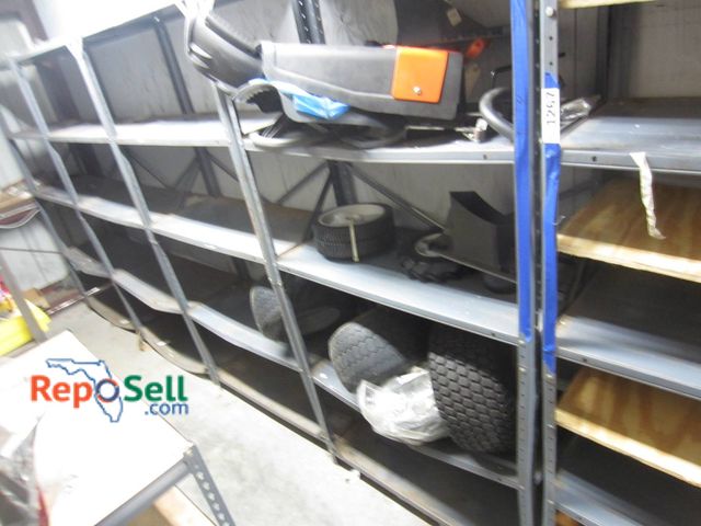 Lot 31-1268 - Contents of Shelves: Husqvarna Lawn Equipment Components, Including Tires, Plastic Body Panels, And ...