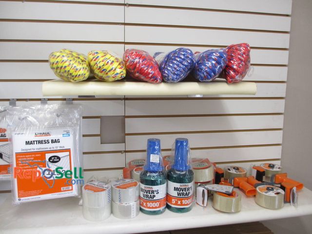 Lot 31-1192 - Moving Supplies Including Mattress Bags, Tape Guns, Movers Wrap, Packing Tape, And Rope. The Lot Fea...