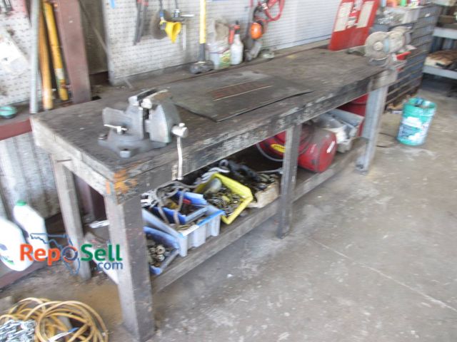 Lot 31-1315 - Heavy-Duty Wooden Workbench With Integrated Bench Vise And Stihl Branded Mat. The Workbench Measures...