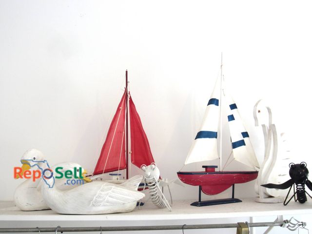 Lot 31-9138 - Decorative collection includes two wooden swans, two painted wooden sailboats, a white metal lobster...