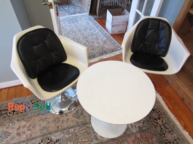 Lot 31-9003 - (2) Mid Century Modern MCM  White Molded Armchairs With Black Cushions And A Round White Table