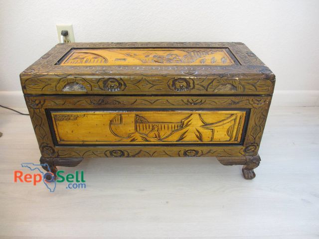 Lot 31-8504 - Hand-Carved Wood Storage Chest 19"H x 29"W x 13"D. Hinged lid With Floral And Architectural Motifs