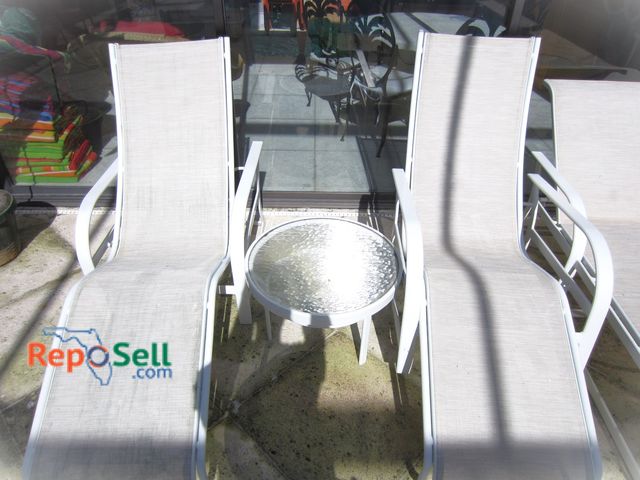 Lot 31-1405 - (2) Outdoor Curved Chaise Lounge Chairs w/Cushions &amp; (1) Side Table, Cushions In Family Room