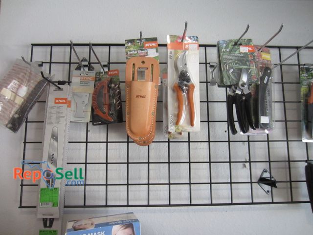 Lot 31-1216 - Stihl New Accessory Lot: chainsaw bars, leather sheaths, bark cutter, etc. - Rack not included