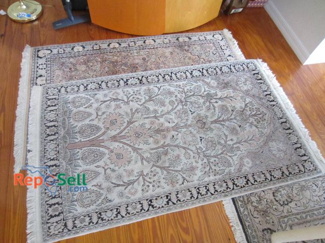 Lot 31-9316 - Two woven area rugs featuring detailed floral patterns. One rug measures approximately 37 by 59 inch...
