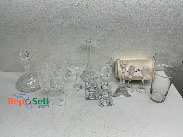 Lot 31-1406 - Cut and pressed crystal glassware and accessories, includes a decanter with stopper, various glasses...