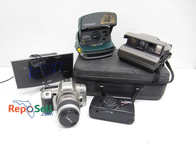 Lot 31-1125 - Cameras and Clock (powers on): (2) Polaroid, Minolta QTsi, etc.