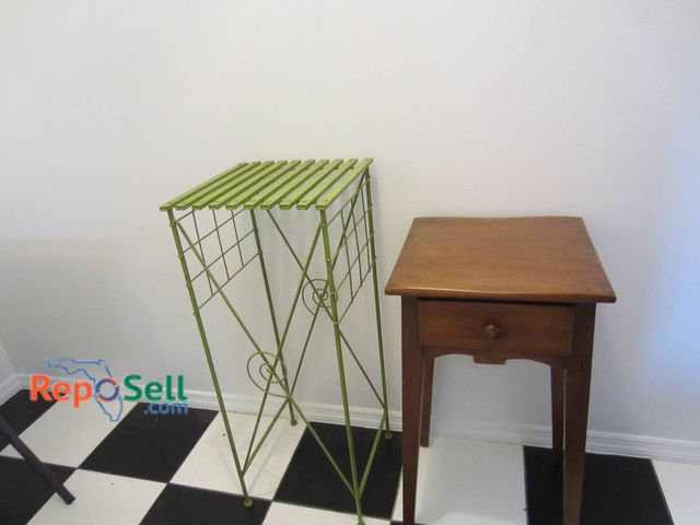 Lot 31-9011 - A Wooden Side Table With Drawer And A Green Metal Plant Stand.