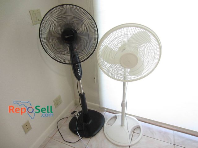 Lot 31-8611 - 2 Oscillating Pedestal Fans Including Amazon Basics With Remote