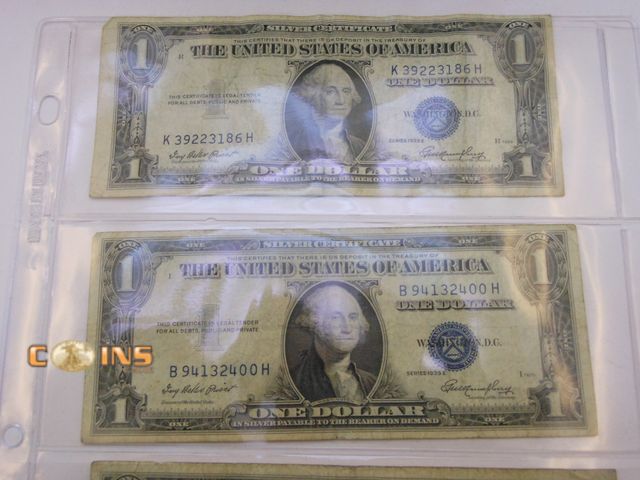 Lot 36-487913 - Lot of Four 1935 Blue Seal Silver Certificates in Three Ring Binder Sheet.