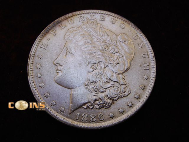 Lot 36-087091 - AU+ 1886 Morgan Silver Dollar.