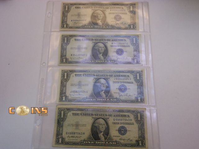 Lot 36-487914 - Lot of Four 1935 Blue Seal Silver Certificates in Three Ring Binder Sheet.