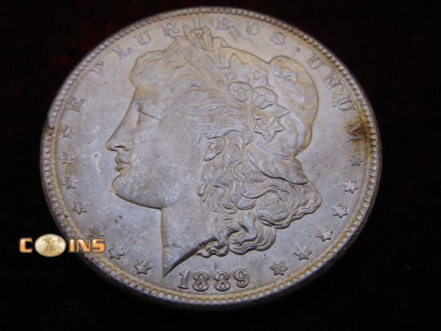 Lot 36-087099 - AU+ 1889 Morgan Silver Dollar.