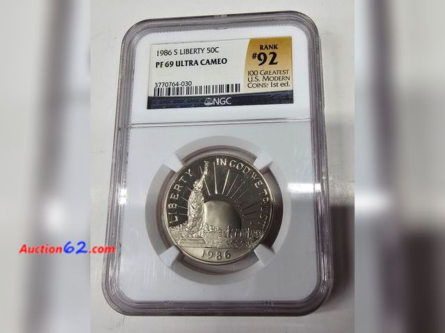 Lot 44-8323b - 1986 S LIBERTY/ELLIS ISLAND PROOF CLAD HALF DOLLAR GRADED PF69 ULTRA CAMEO BY NGC. 1 POINT SHY OF A PERFECT COIN! RANKED #92 IN THE 100 GREA...