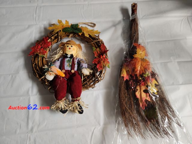 Lot 44-2135g - 1 fall scarecrow wreath measures approx 12 in H x 12 in W. 1 decorated fall broom Measures approx. W3 in H x 8 in W at broom bristles. New n...
