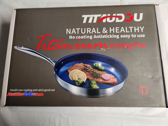 Lot 44-2117g - 1 Titaudou Natural and Healthy No coating antisticking easy to use Titanium frying pan. Approx 11 inches. Steel handle. Navy blue inside. Ca...