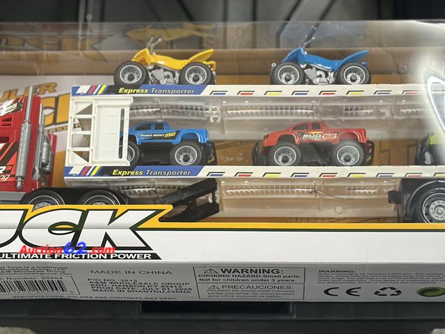 Lot 44-7510b - 1:32 semi truck with friction power from totally cool toys. Comes with 3 four wheelers and 3 trucks. New. Ages 3+ See All Photo's Not Tested...