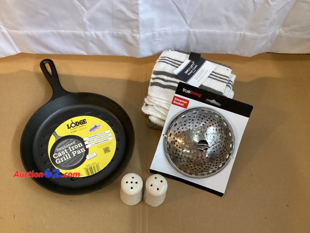 Lot 44-7719i - Lot of (1) steamer basket, (1) set of 12 washcloths, (1) set of hobnail salt and pepper shakers, (1) Lodge 9” cast iron grill pan.  Appears ...