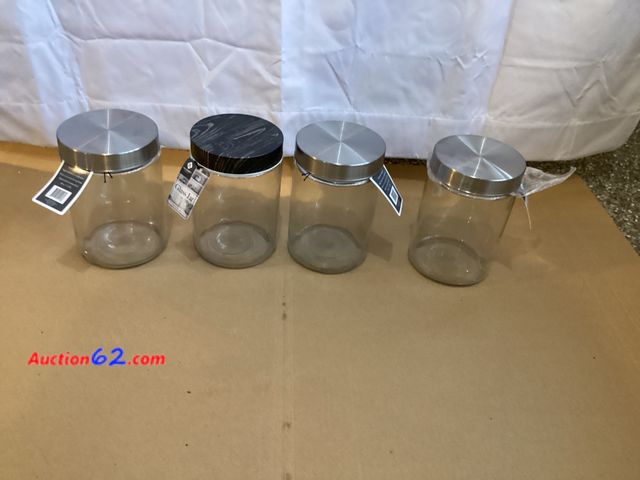 Lot 44-7711i - Lot of (4) glass storage jars with tin lids.  Appears New, A basic inspection has been given to this item. Sold AS-IS. See All Photo's