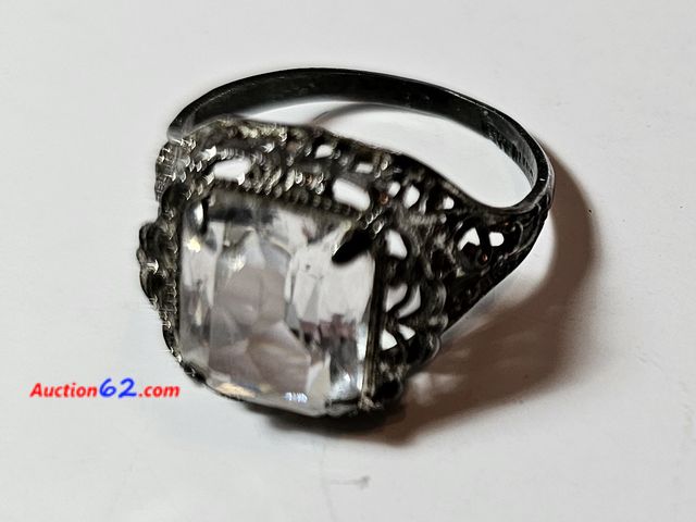Lot 44-8359j - .925 STERLING RING WITH REALLY BIG CLEAR STONE. SIZE IS APPROX A 5 AND A HALF. PLEASE LOOK AT THE PHOTO OF THE RING ON A SIZER FOR YOUR OPIN...