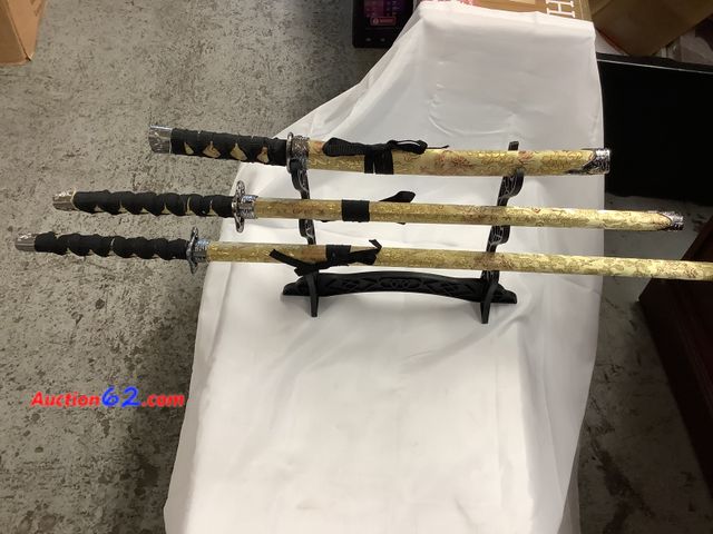 Lot 44-6104w - 3 pc Samurai sword set with display rack. Blades are metal but not sharp. New. See All Photo's Not Tested Never opened, Factory Sealed