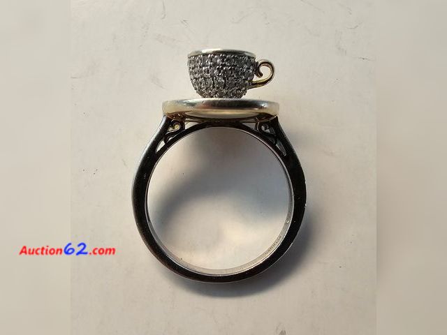 Lot 44-8386w - .925 STERLING SILVER RING WITH A TEA CUP WITH LOTS OF PRETTY STONES. APPROXIMATELY A SIZE 7. PLEASE LOOK AT THE PHOTO OF THE RING ON THE SIZ...