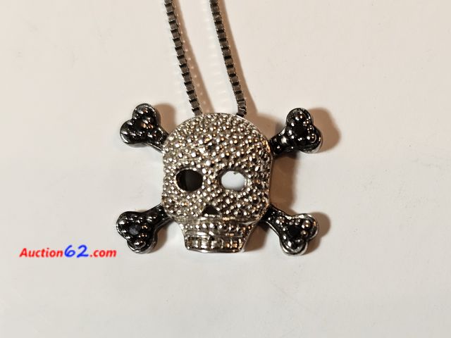 Lot 44-8363j - .925 STERLING SILVER SKULL AND CROSSBONES LOADED WITH BLINGY JEWELS AND STONES ON A .925 STERLING SILVER NECKLACE. WEIGHS 0.1 TROY OUNCES.-T