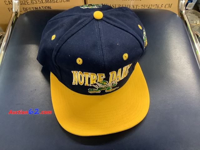 Lot 44-7539b - Notre Dame snap back ball cap made in Taiwan by AJD NEW. See All Photo's Not Tested Never opened, Factory Sealed Unmarked, No barcodes